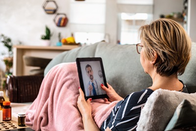 A woman taking a virtual appointment at home